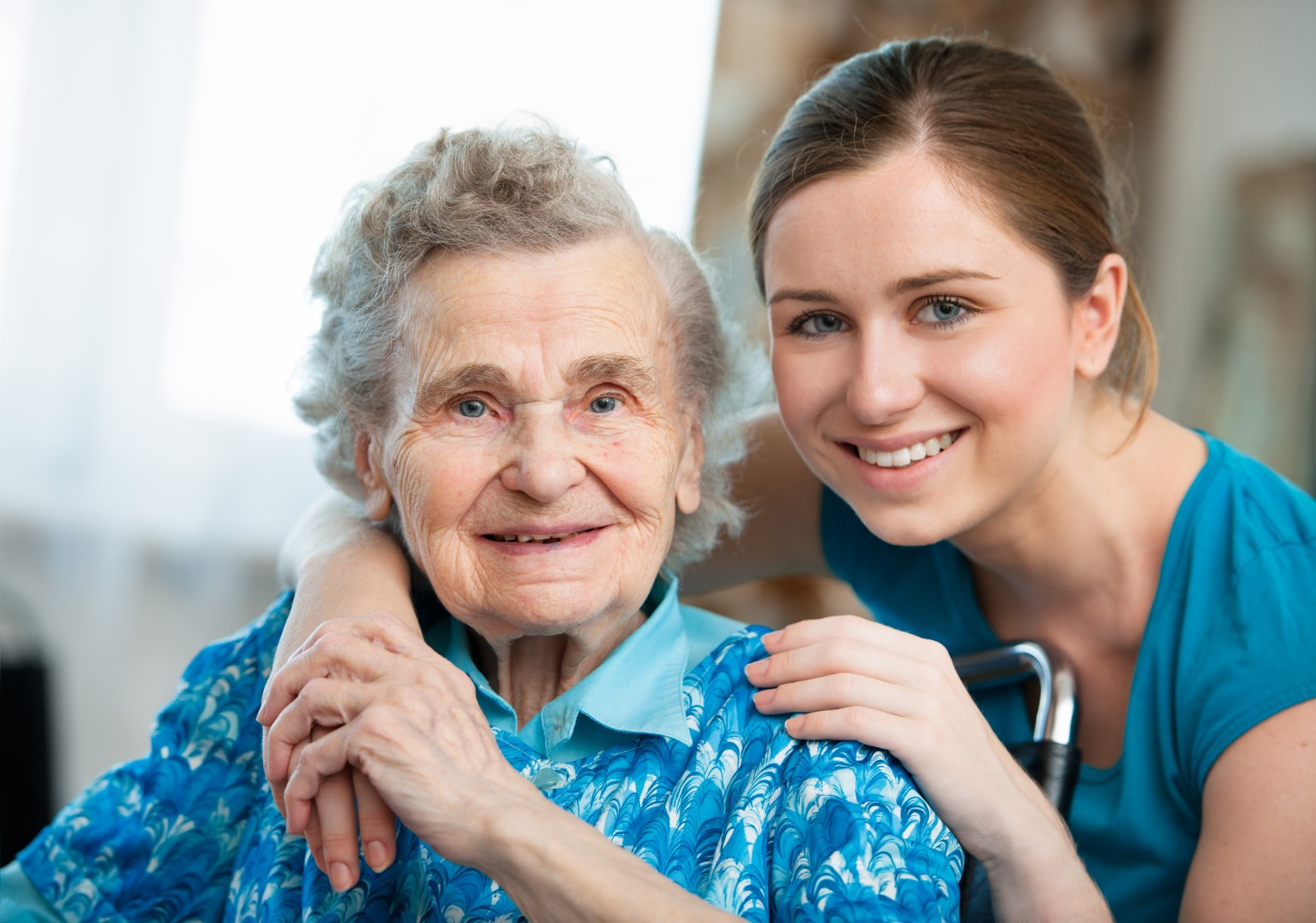 Caregiver supporting an older gentleman with warmth and dignity